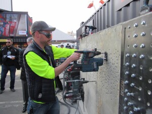 A cordless rotary hammer combined with a battery-powered dust collection system.